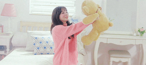 kang seulgi hugging a medium sized stuffed bear